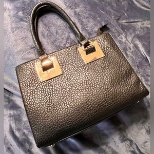 Black leather bag with gold accents